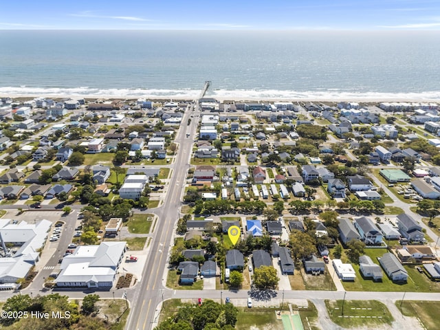 drone / aerial view with a beach view, a residential view, and a water view