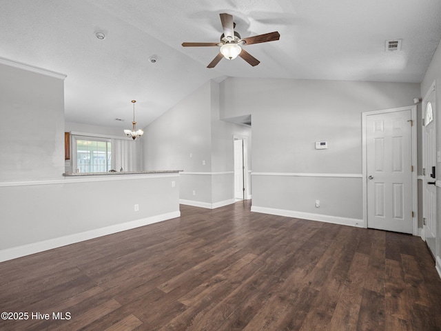spare room featuring visible vents, lofted ceiling, baseboards, dark wood-style floors, and ceiling fan with notable chandelier