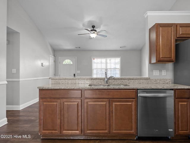 kitchen with a sink, light stone countertops, a ceiling fan, and dishwasher