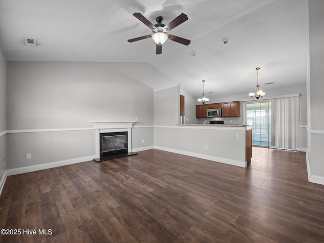unfurnished living room featuring dark wood-style flooring, a glass covered fireplace, ceiling fan with notable chandelier, vaulted ceiling, and visible vents