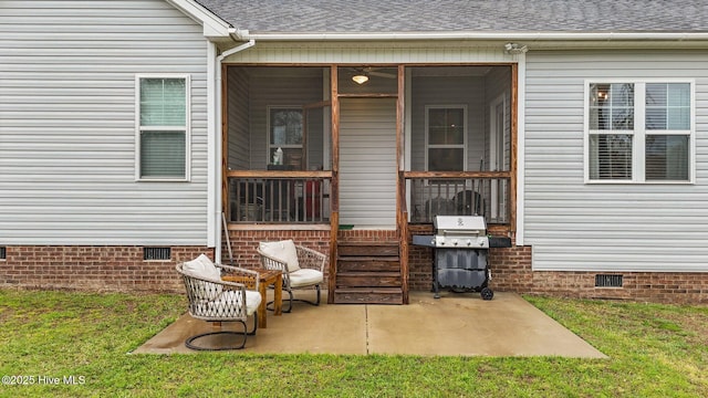 exterior space featuring roof with shingles, a patio area, a yard, and crawl space