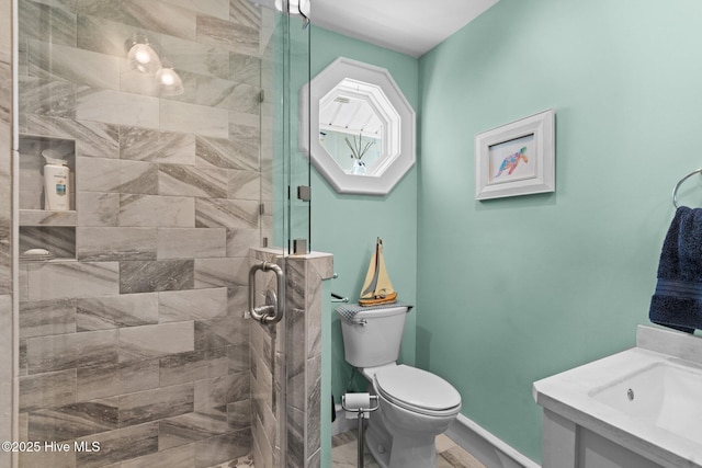 bathroom featuring toilet, baseboards, and a stall shower