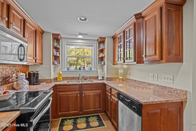 1308 Ann St Unit 16, Beaufort, NC 28516 - kitchen featuring stainless steel appliances, a sink, light stone counters, brown cabinets, and open shelves
