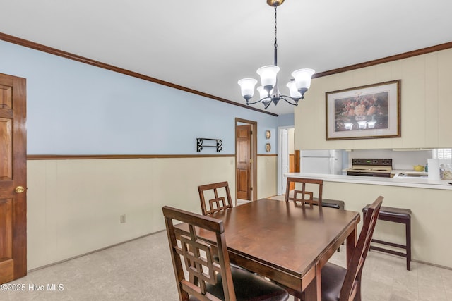 dining area featuring crown molding and a notable chandelier