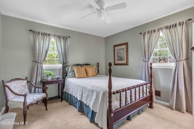 carpeted bedroom featuring visible vents, baseboards, and a ceiling fan