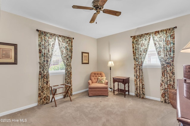sitting room with ceiling fan, carpet flooring, and plenty of natural light
