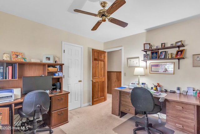 office area featuring ceiling fan, light colored carpet, and baseboards