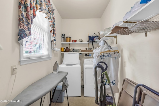 clothes washing area featuring washing machine and dryer and laundry area