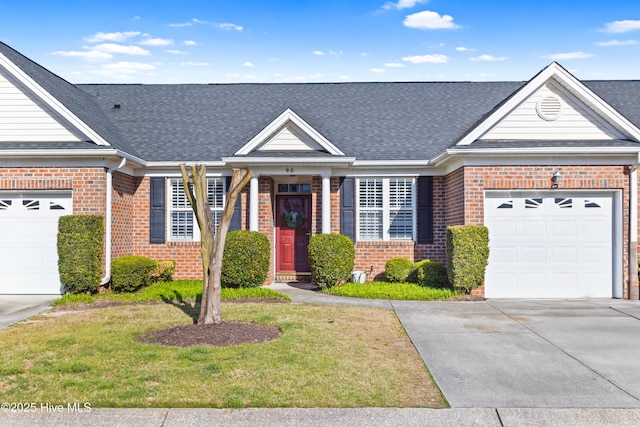 5006 Carleton Dr Unit 90, Wilmington, NC 28403 - view of front facade featuring brick siding, concrete driveway, a garage, and a shingled roof