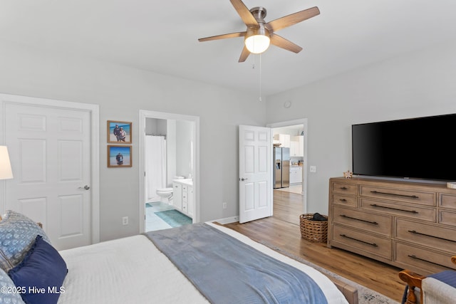 5006 Carleton Dr Unit 90, Wilmington, NC 28403 - bedroom with stainless steel refrigerator with ice dispenser, light wood-style flooring, connected bathroom, and ceiling fan