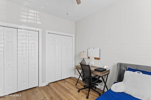 5006 Carleton Dr Unit 90, Wilmington, NC 28403 - bedroom featuring multiple closets, wood finished floors, a ceiling fan, and baseboards