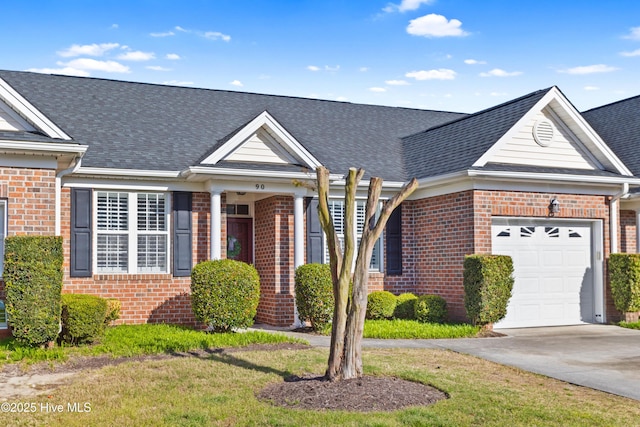 5006 Carleton Dr Unit 90, Wilmington, NC 28403 - view of front facade with brick siding, an attached garage, a shingled roof, and driveway