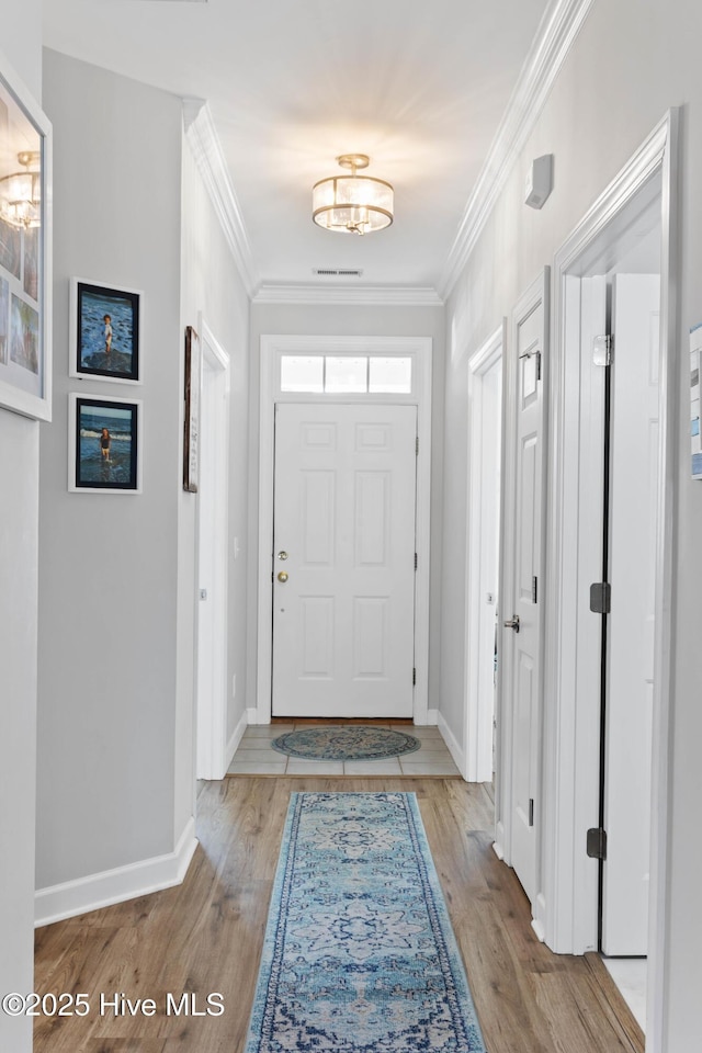 5006 Carleton Dr Unit 90, Wilmington, NC 28403 - foyer featuring light wood-style floors, crown molding, and baseboards