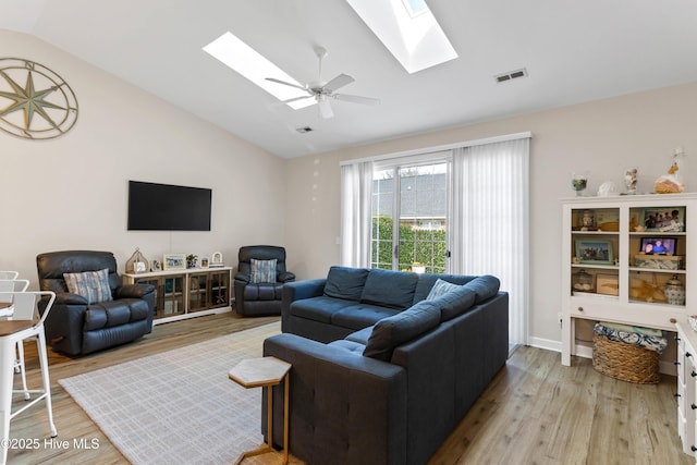 5006 Carleton Dr Unit 90, Wilmington, NC 28403 - living room featuring a skylight, vaulted ceiling, light wood-type flooring, and a ceiling fan