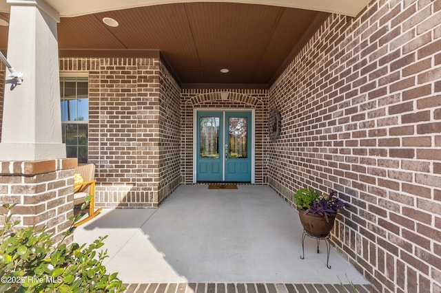 entrance to property with brick siding and french doors