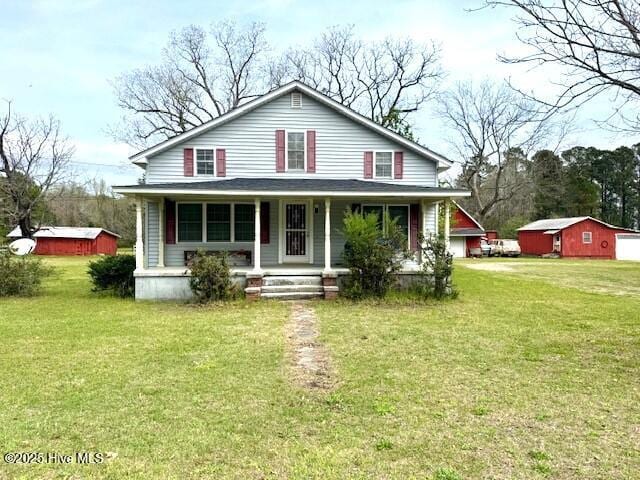 1885 NC-306, Grantsboro, NC 28529 - view of front facade with a porch, a front yard, and an outbuilding
