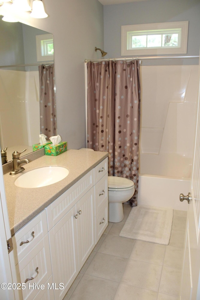 bathroom featuring vanity, tile patterned flooring, shower / bathtub combination with curtain, and toilet