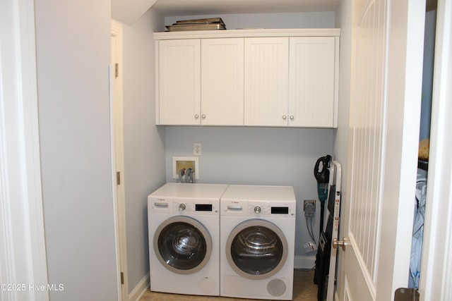 laundry area with washing machine and dryer and cabinet space