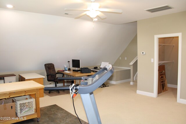 carpeted office space featuring visible vents, a ceiling fan, and baseboards
