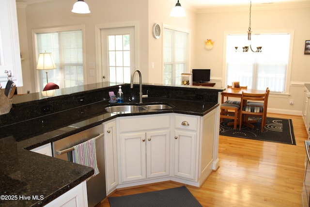 kitchen with light wood-style flooring, a sink, white cabinetry, and crown molding