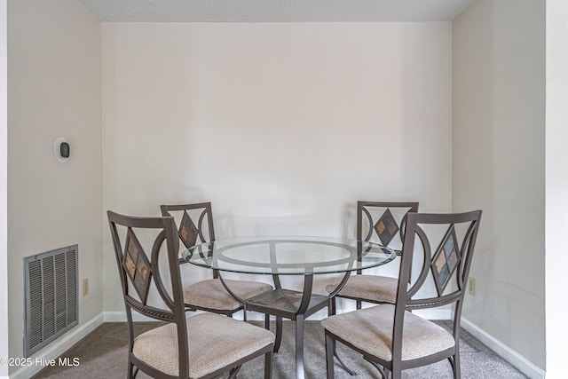 dining room with visible vents, baseboards, and carpet flooring