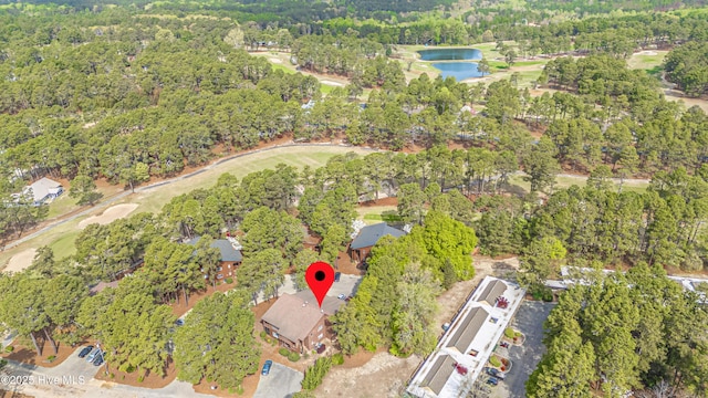 aerial view with golf course view and a water view