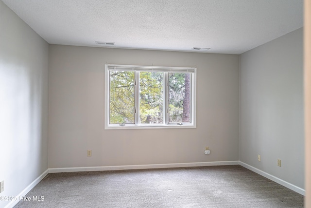 unfurnished room featuring carpet flooring, baseboards, and visible vents