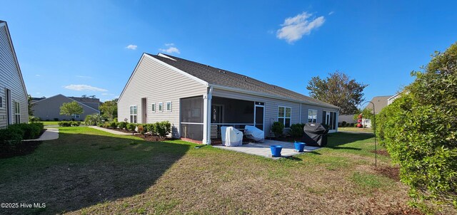 1905 Coleman Lake Dr, Calabash, NC 28467 - rear view of house with a patio, a yard, and a sunroom