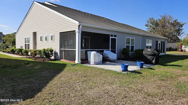 1905 Coleman Lake Dr, Calabash, NC 28467 - rear view of property featuring a patio area, a sunroom, a lawn, and a shingled roof