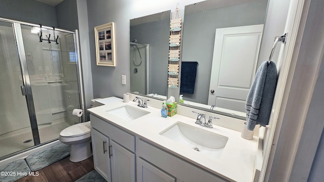 1905 Coleman Lake Dr, Calabash, NC 28467 - bathroom featuring toilet, a stall shower, double vanity, and wood finished floors