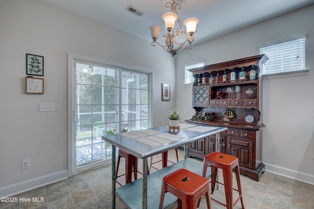 8603 Lanvale Forest Dr, Leland, NC 28451 - dining space featuring baseboards, a chandelier, and stone finish flooring