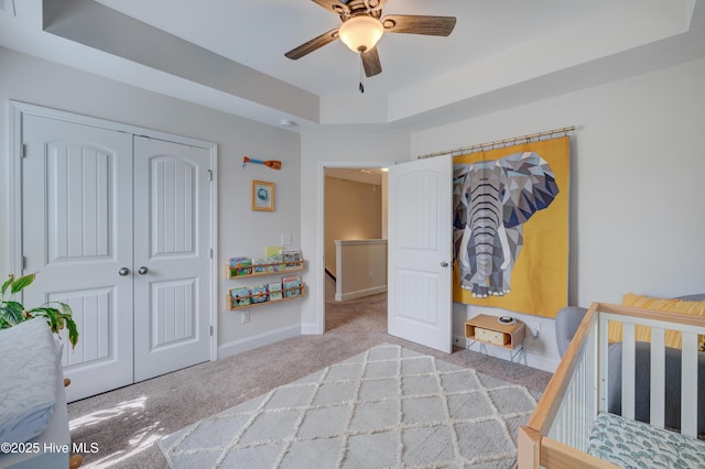 8603 Lanvale Forest Dr, Leland, NC 28451 - bedroom featuring a raised ceiling, a closet, carpet flooring, baseboards, and a ceiling fan