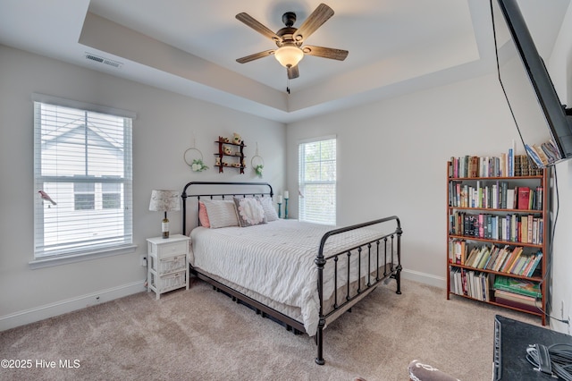 8603 Lanvale Forest Dr, Leland, NC 28451 - bedroom with a tray ceiling, carpet, baseboards, and ceiling fan
