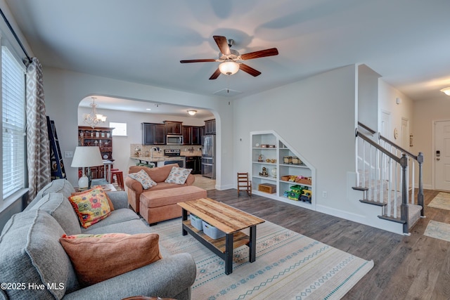 8603 Lanvale Forest Dr, Leland, NC 28451 - living room featuring arched walkways, stairway, ceiling fan, wood finished floors, and baseboards