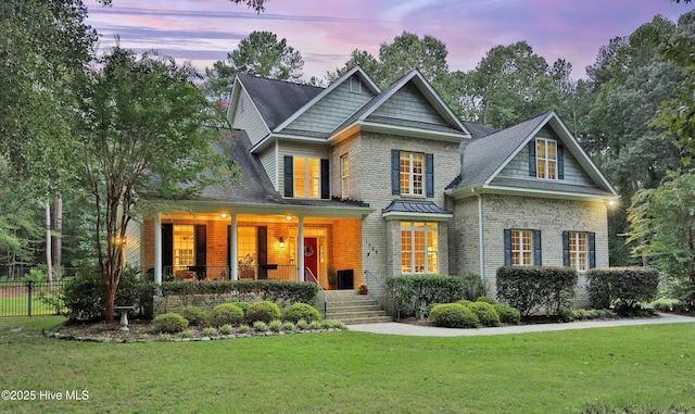 view of front of property with covered porch and brick siding