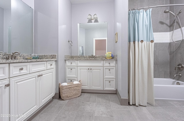 full bathroom featuring shower / bath combo, two vanities, and baseboards