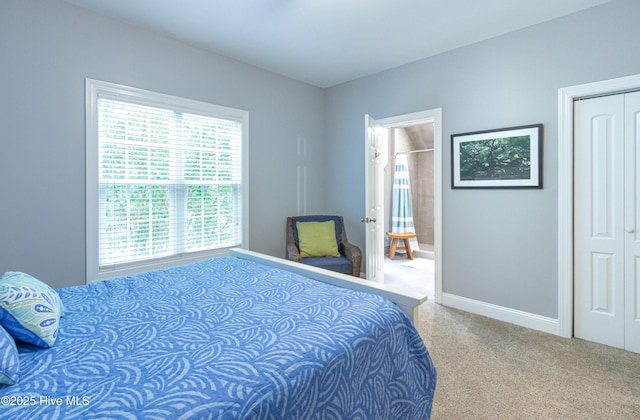bedroom with carpet, baseboards, and a closet