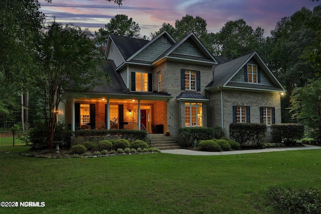 view of front of house featuring covered porch and brick siding