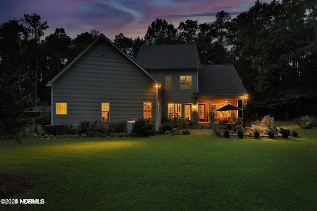 rear view of house with a yard