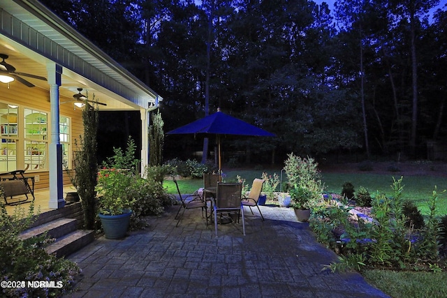 patio at twilight featuring a ceiling fan and outdoor dining space