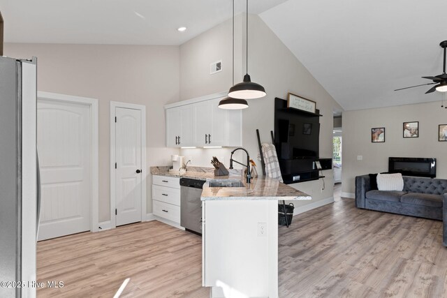 2665 Ash Little River Rd NW, Longwood, NC 28452 - kitchen featuring open floor plan, a sink, a peninsula, stainless steel appliances, and a kitchen breakfast bar