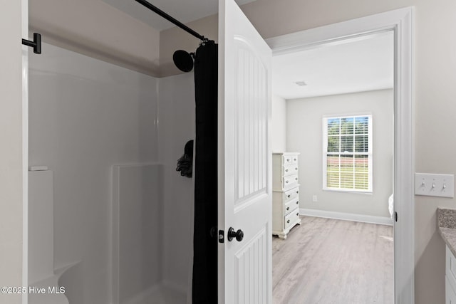 2665 Ash Little River Rd NW, Longwood, NC 28452 - full bathroom featuring wood finished floors, curtained shower, vanity, and baseboards