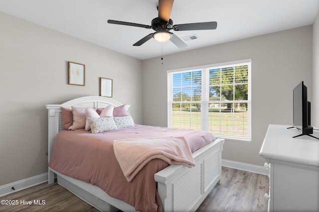 2665 Ash Little River Rd NW, Longwood, NC 28452 - bedroom featuring baseboards, light wood-style flooring, and ceiling fan