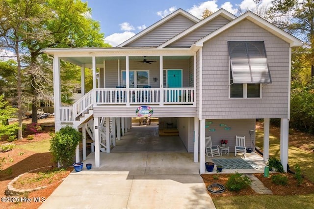 334 NE 48th St, Oak Island, NC 28465 - beach home featuring a carport, a porch, a ceiling fan, driveway, and stairway