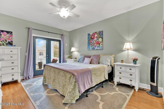 334 NE 48th St, Oak Island, NC 28465 - bedroom featuring french doors, access to exterior, light wood-type flooring, and baseboards