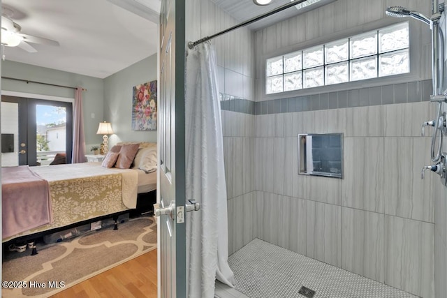 334 NE 48th St, Oak Island, NC 28465 - bathroom featuring ensuite bath, healthy amount of natural light, a tile shower, and wood finished floors