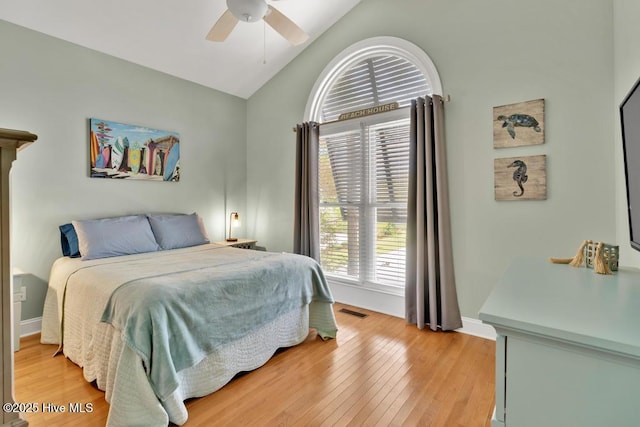 334 NE 48th St, Oak Island, NC 28465 - bedroom featuring vaulted ceiling, light wood finished floors, a ceiling fan, and baseboards