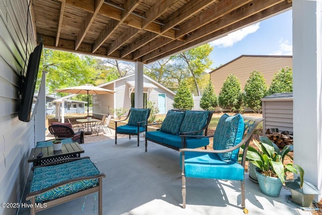 334 NE 48th St, Oak Island, NC 28465 - view of patio with outdoor lounge area and an outdoor structure