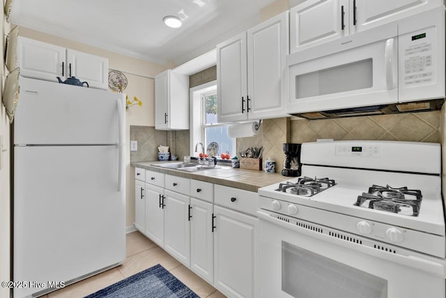 334 NE 48th St, Oak Island, NC 28465 - kitchen with white appliances, white cabinetry, tasteful backsplash, and light tile patterned floors