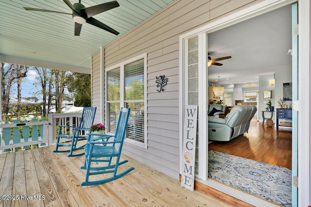 334 NE 48th St, Oak Island, NC 28465 - wooden porch with ceiling fan